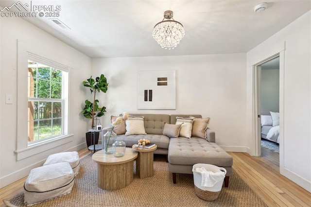 825 N Wahsatch Ave, Colorado Springs, CO 80903 - living room featuring light wood finished floors, a chandelier, and baseboards