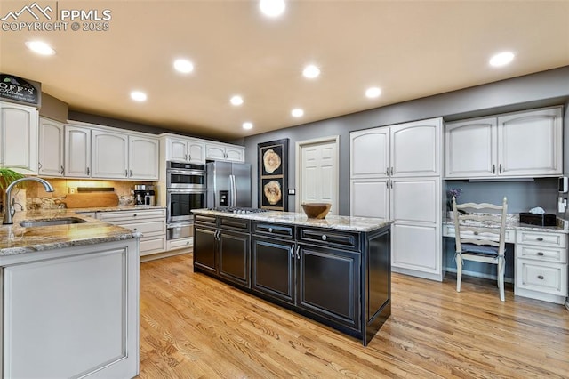 8005 Hedgewood Way, Colorado Springs, CO 80919 - kitchen featuring a sink, stainless steel appliances, white cabinetry, light stone counters, and recessed lighting