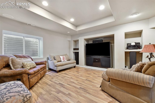 8005 Hedgewood Way, Colorado Springs, CO 80919 - living room featuring light wood-style floors, built in shelves, recessed lighting, and a raised ceiling