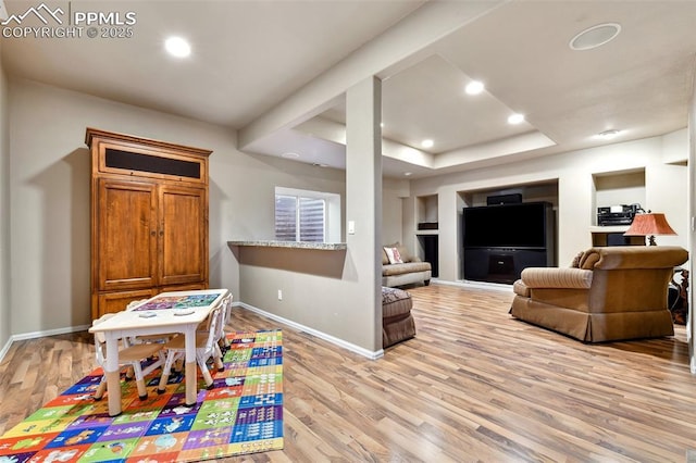 8005 Hedgewood Way, Colorado Springs, CO 80919 - rec room with light wood-style floors, baseboards, recessed lighting, a tray ceiling, and built in shelves