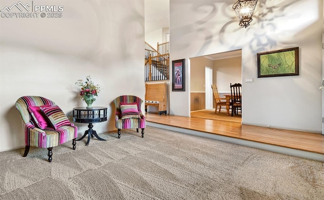 8005 Hedgewood Way, Colorado Springs, CO 80919 - sitting room featuring carpet, stairs, baseboards, crown molding, and a towering ceiling