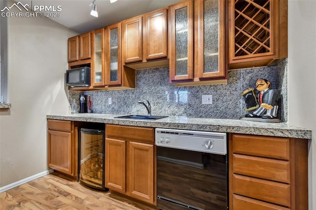 8005 Hedgewood Way, Colorado Springs, CO 80919 - kitchen featuring black appliances, beverage cooler, a sink, light countertops, and light wood-type flooring