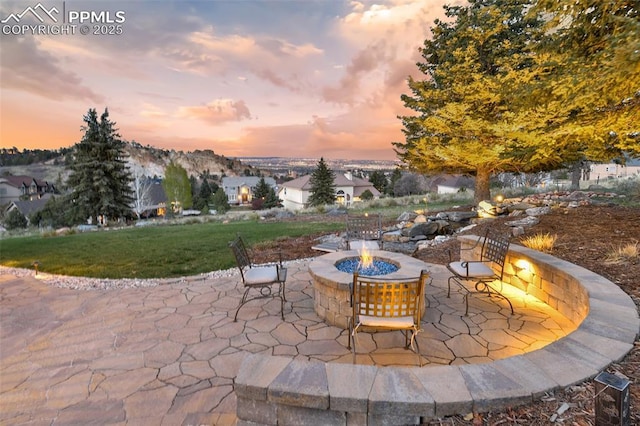 8005 Hedgewood Way, Colorado Springs, CO 80919 - patio terrace at dusk with an outdoor fire pit and a yard