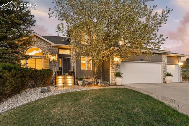 8005 Hedgewood Way, Colorado Springs, CO 80919 - view of front facade with stone siding, an attached garage, driveway, and a front yard