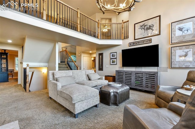 8005 Hedgewood Way, Colorado Springs, CO 80919 - carpeted living room featuring a chandelier, stairway, and a towering ceiling