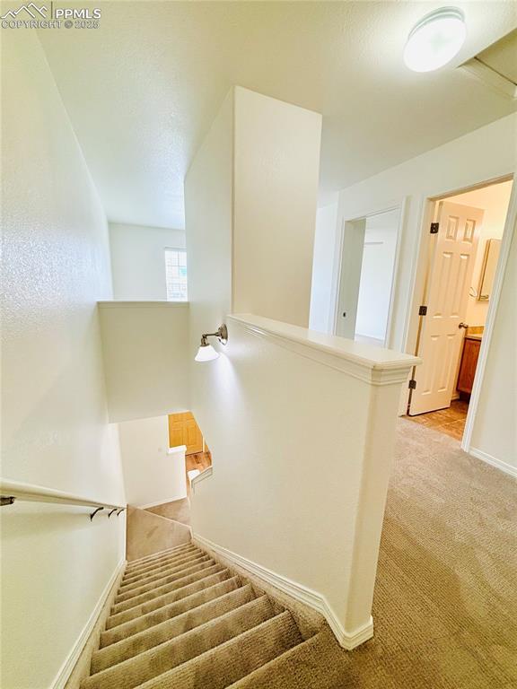 10525 Wells Pt, Fountain, CO 80817 - stairway with carpet flooring and baseboards