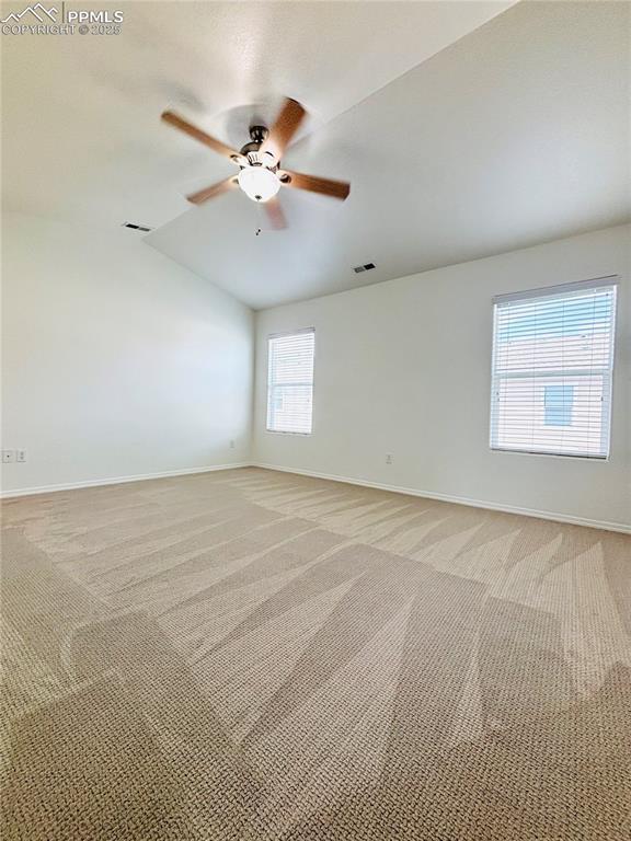 10525 Wells Pt, Fountain, CO 80817 - empty room featuring lofted ceiling, baseboards, light colored carpet, and a ceiling fan