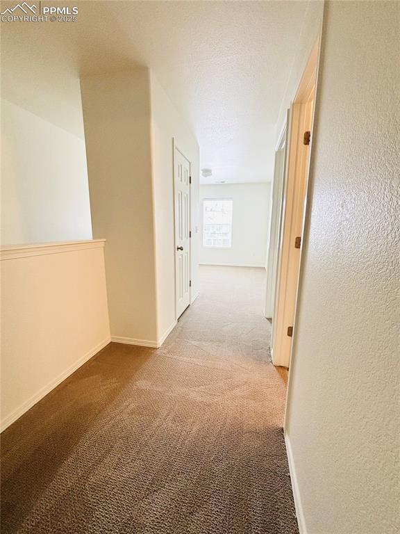 10525 Wells Pt, Fountain, CO 80817 - hall featuring carpet floors and baseboards