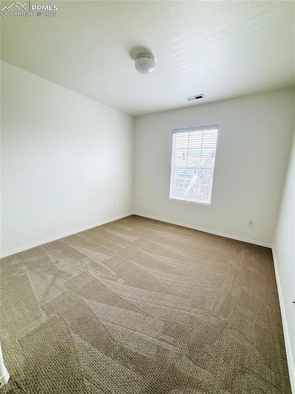 10525 Wells Pt, Fountain, CO 80817 - carpeted spare room featuring baseboards