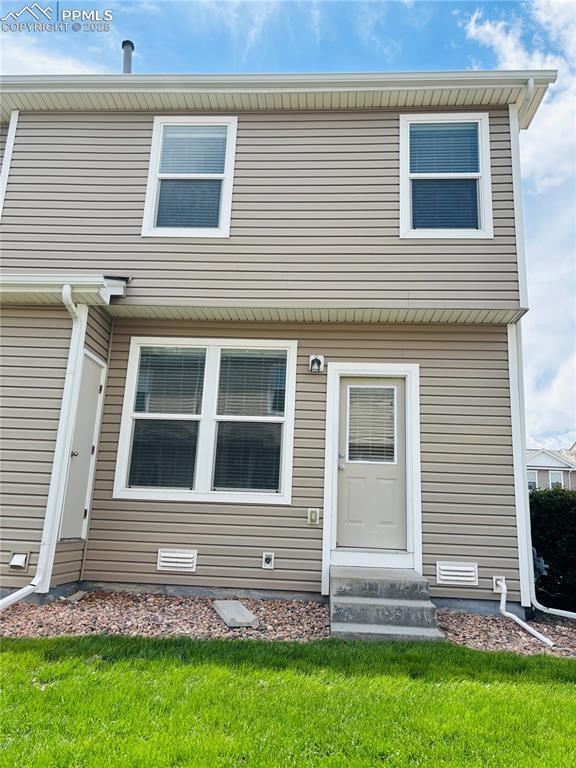 10525 Wells Pt, Fountain, CO 80817 - view of front of house featuring entry steps and a front lawn