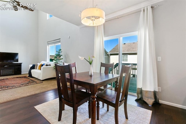 dining area with hardwood / wood-style floors and baseboards