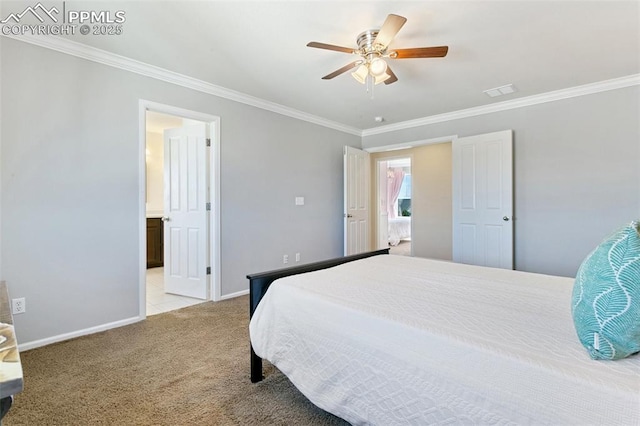 carpeted bedroom featuring ornamental molding, baseboards, a ceiling fan, and ensuite bath