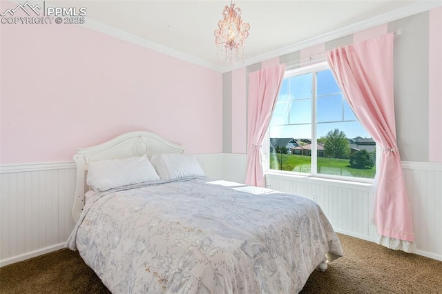 carpeted bedroom with a wainscoted wall and ornamental molding