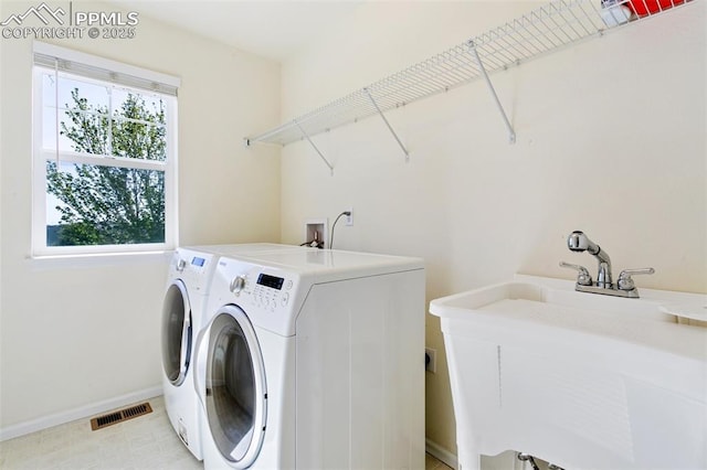 laundry area featuring independent washer and dryer and baseboards