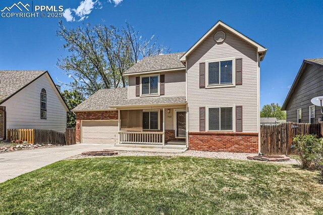 2068 Silkwood Dr, Colorado Springs, CO 80920 - traditional-style house with brick siding, covered porch, concrete driveway, an attached garage, and a shingled roof