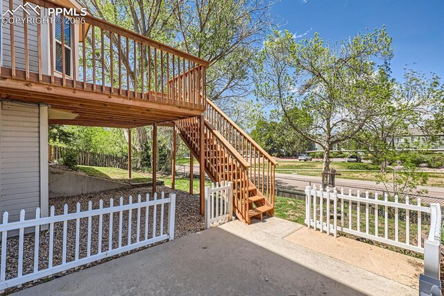 2068 Silkwood Dr, Colorado Springs, CO 80920 - view of patio featuring stairway, fence, and a deck