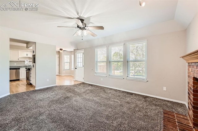 2068 Silkwood Dr, Colorado Springs, CO 80920 - unfurnished living room with light carpet, ceiling fan, baseboards, and a brick fireplace
