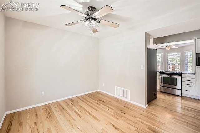 2068 Silkwood Dr, Colorado Springs, CO 80920 - empty room with light wood-style floors, ceiling fan, and baseboards