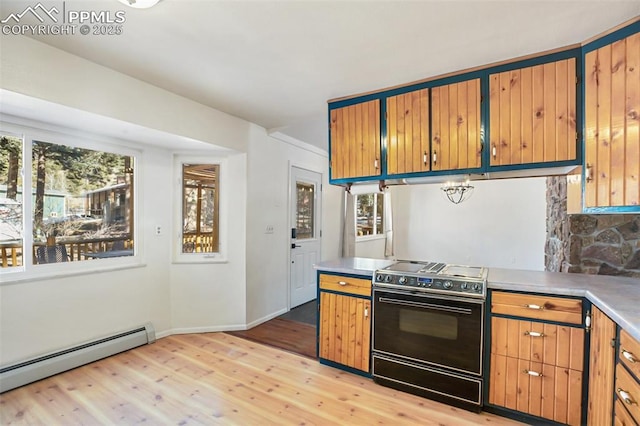 kitchen with electric range, a baseboard radiator, light wood-style floors, light countertops, and baseboards