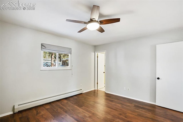spare room featuring a baseboard heating unit, ceiling fan, wood finished floors, and baseboards