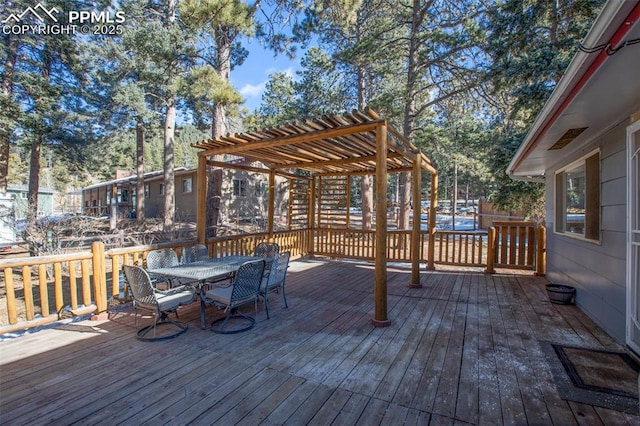 wooden terrace with a pergola and outdoor dining space