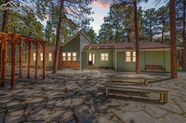 6940 Franciville Rd, Colorado Springs, CO 80908 - rear view of house with a patio area and a shingled roof