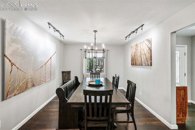 6940 Franciville Rd, Colorado Springs, CO 80908 - dining room with track lighting, a chandelier, wood finished floors, baseboards, and a textured ceiling