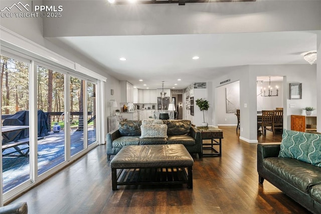 6940 Franciville Rd, Colorado Springs, CO 80908 - living room with a chandelier, dark wood-style floors, recessed lighting, and baseboards