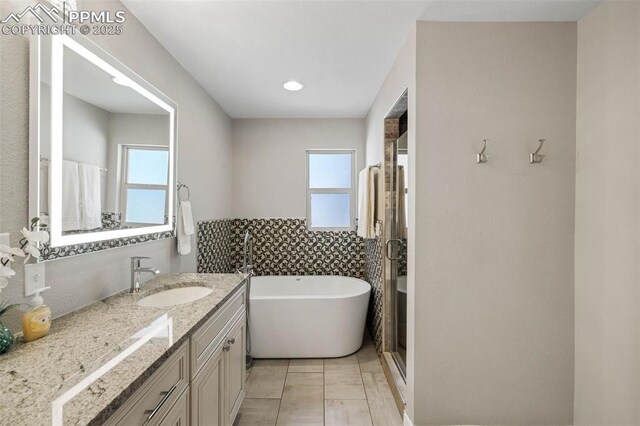 6940 Franciville Rd, Colorado Springs, CO 80908 - full bathroom featuring vanity, a soaking tub, and tile patterned flooring