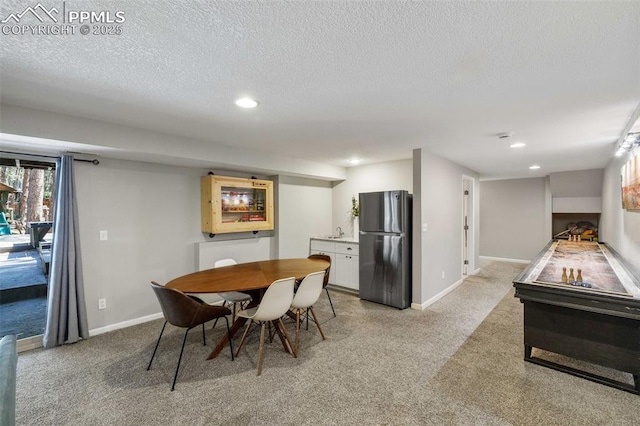 6940 Franciville Rd, Colorado Springs, CO 80908 - dining space with light colored carpet, recessed lighting, a textured ceiling, and baseboards