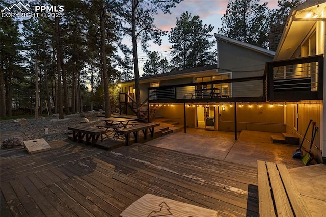 6940 Franciville Rd, Colorado Springs, CO 80908 - deck at dusk featuring stairs and a patio area
