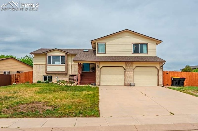 780 Foxwood Dr, Colorado Springs, CO 80911 - tri-level home with brick siding, a garage, concrete driveway, and a shingled roof