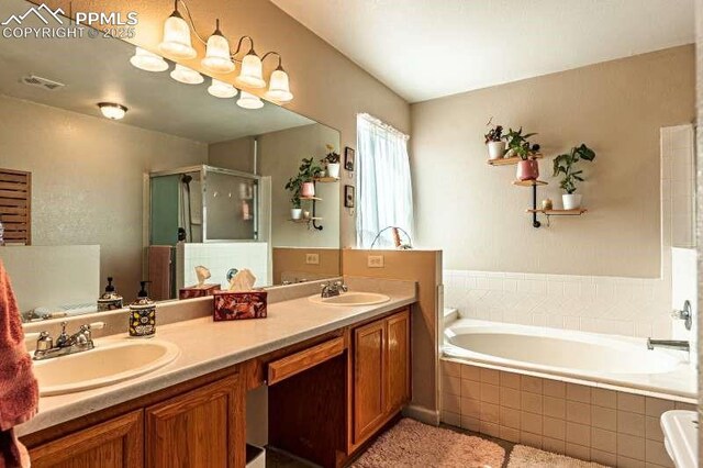 780 Foxwood Dr, Colorado Springs, CO 80911 - full bathroom featuring a stall shower, double vanity, and a garden tub