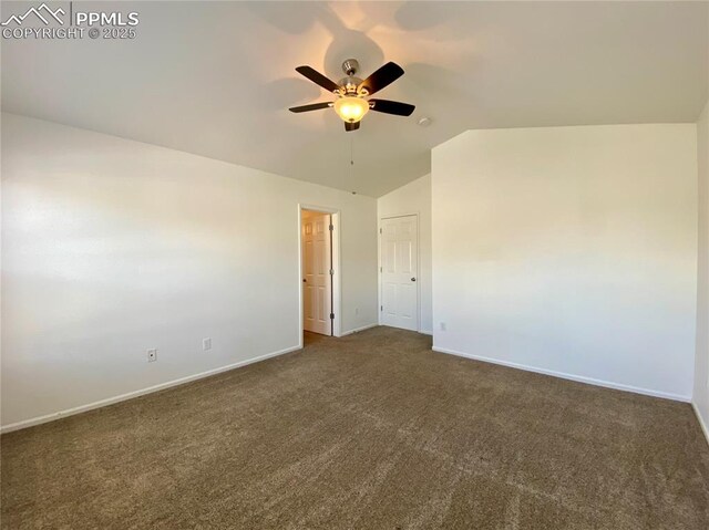 7513 Sandy Springs Pt, Fountain, CO 80817 - unfurnished bedroom with dark colored carpet, baseboards, vaulted ceiling, and a ceiling fan
