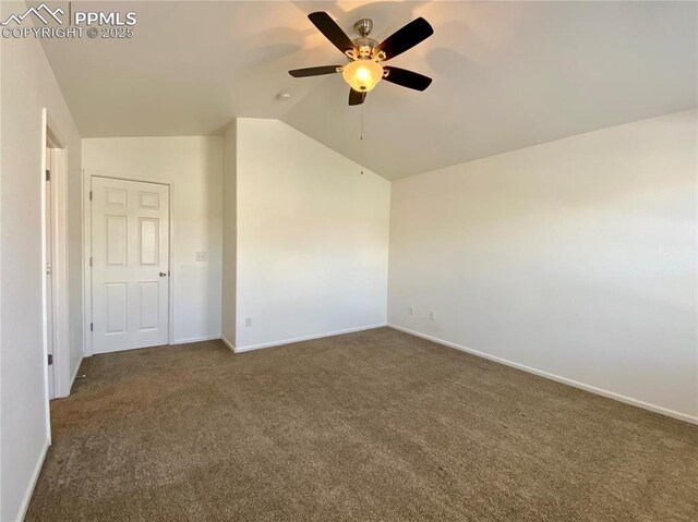 7513 Sandy Springs Pt, Fountain, CO 80817 - spare room with dark carpet, vaulted ceiling, ceiling fan, and baseboards