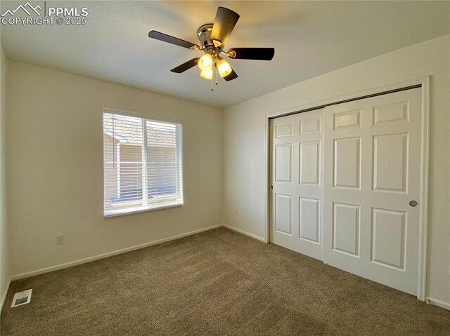 7513 Sandy Springs Pt, Fountain, CO 80817 - unfurnished bedroom featuring carpet, a closet, baseboards, and ceiling fan