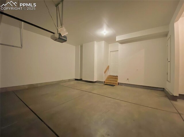 7513 Sandy Springs Pt, Fountain, CO 80817 - garage with baseboards and a garage door opener