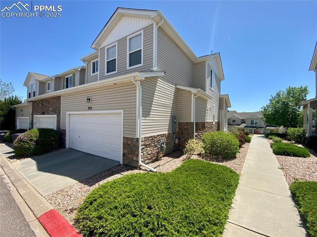 7513 Sandy Springs Pt, Fountain, CO 80817 - view of home's exterior with stone siding, a garage, and concrete driveway