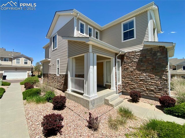 7513 Sandy Springs Pt, Fountain, CO 80817 - view of front of home featuring a porch and stone siding