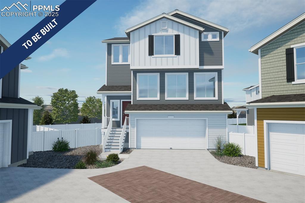 5660 Dakan Loop, Colorado Springs, CO 80927 - view of front of home with fence, decorative driveway, board and batten siding, and an attached garage