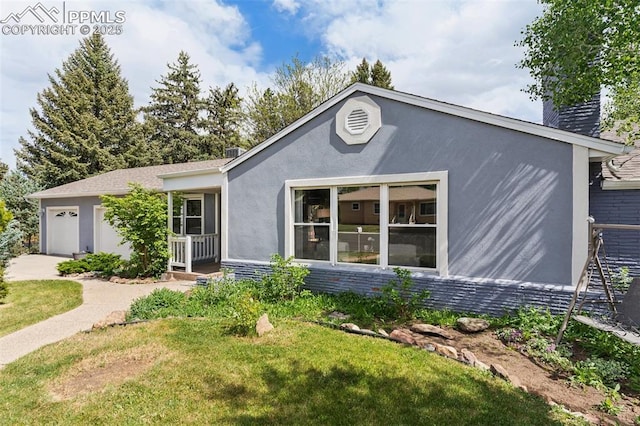 603 Three Eagles St, Colorado Springs, CO 80905 - ranch-style home featuring stucco siding, an attached garage, a chimney, and a front yard