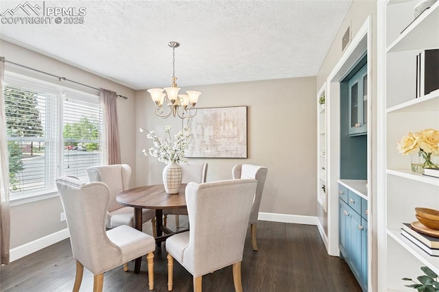 603 Three Eagles St, Colorado Springs, CO 80905 - dining space with a chandelier, dark wood-style flooring, baseboards, and a textured ceiling