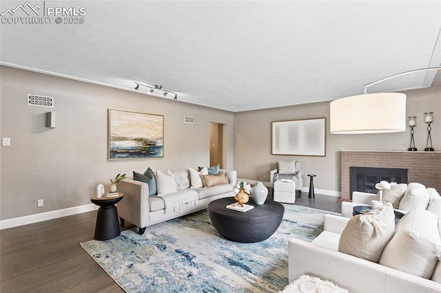 603 Three Eagles St, Colorado Springs, CO 80905 - living area featuring wood finished floors, baseboards, and a fireplace