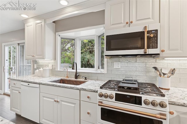 603 Three Eagles St, Colorado Springs, CO 80905 - kitchen with white appliances, a sink, and white cabinetry