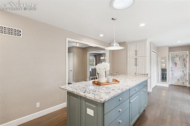 603 Three Eagles St, Colorado Springs, CO 80905 - kitchen with baseboards, white cabinetry, dark wood finished floors, a kitchen island, and decorative light fixtures