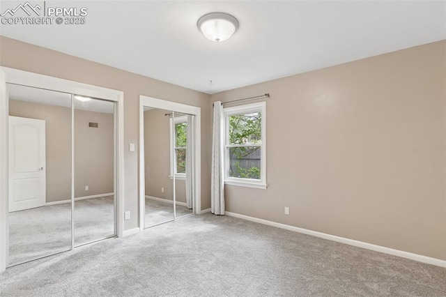 603 Three Eagles St, Colorado Springs, CO 80905 - unfurnished bedroom featuring multiple closets, carpet flooring, and baseboards