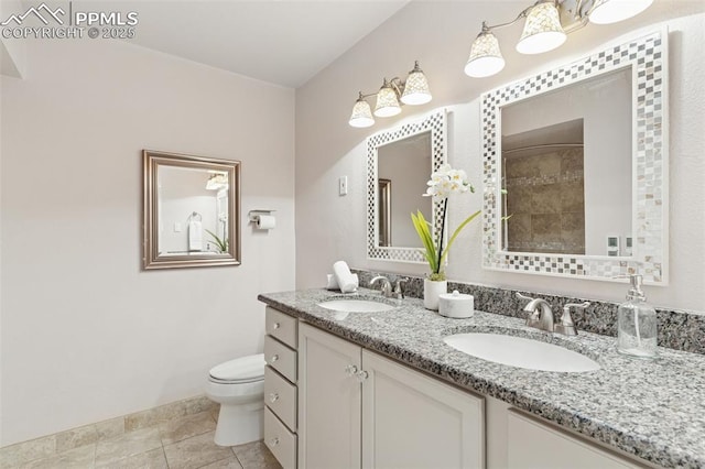 603 Three Eagles St, Colorado Springs, CO 80905 - bathroom with double vanity, toilet, and tile patterned flooring