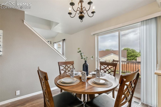 8463 Shadow Run Ln, Fountain, CO 80817 - dining space featuring wood finished floors, baseboards, and a chandelier
