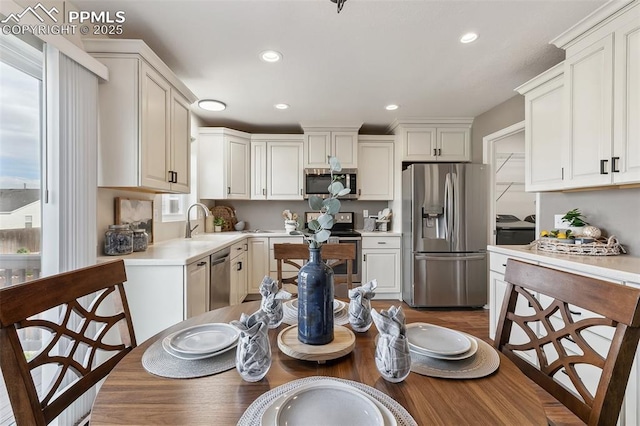8463 Shadow Run Ln, Fountain, CO 80817 - kitchen with appliances with stainless steel finishes, light countertops, light wood finished floors, recessed lighting, and a sink