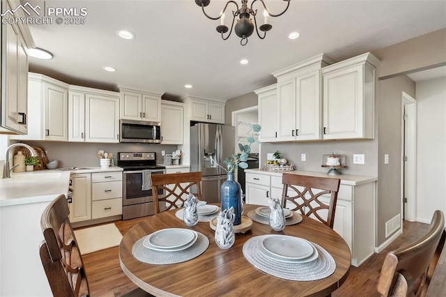 8463 Shadow Run Ln, Fountain, CO 80817 - dining space featuring light wood-style flooring, a chandelier, and recessed lighting